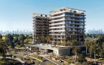 La résidence Inara est un immeuble résidentiel moderne de plusieurs étages avec de grands balcons, entouré de palmiers et de jardins paysagers. Une piscine étincelante se trouve à l'avant, avec une ligne d'horizon lointaine de la ville visible sous un ciel bleu clair.
