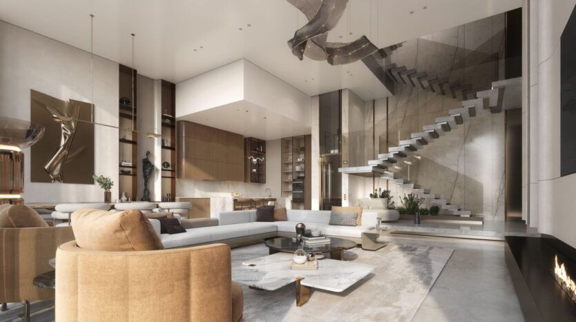 Le salon spacieux et moderne de The Tides by Amis se caractérise par des tons neutres, un mobilier contemporain, une table basse en marbre, un escalier flottant, de grandes fenêtres et des éclairages élégants. L'agencement ouvert comprend un espace cuisine visible et des accents décoratifs.