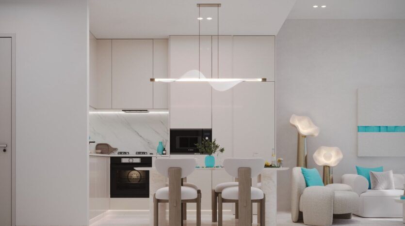 Cuisine et salle à manger modernes avec des armoires blanches, des appareils encastrés et un décor minimaliste. Les coussins turquoise Reef 996 sur les chaises de la petite table et l'éclairage doux créent une atmosphère lumineuse et confortable.