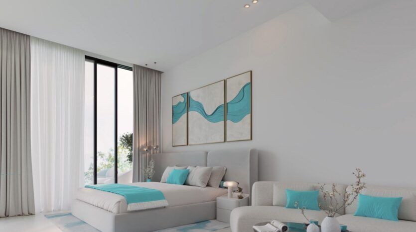 Chambre à coucher moderne avec une grande fenêtre, des meubles gris clair et des accents sarcelle dans le style de Reef 996. Le lit est orné d'oreillers et d'une couverture de couleur sarcelle, avec une œuvre d'art abstraite de couleur sarcelle au-dessus. Un petit canapé et une table basse complètent l'espace naturellement éclairé.