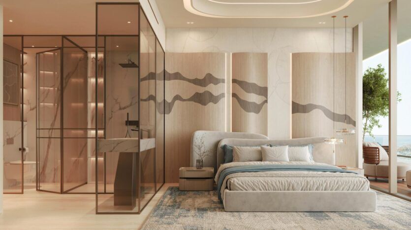 Chambre moderne dotée d'un grand lit, aux tons neutres et doux, avec des œuvres d'art abstraites aux murs, une salle de bains vitrée, de la lumière naturelle et une vue sur l'océan à travers les baies vitrées de la résidence Vue Dorée. La décoration minimaliste et les plantes apportent une touche de sérénité.