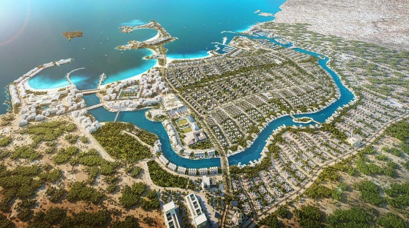 Aerial view of a Dubai resort featuring complex canal systems and carefully landscaped residential areas, surrounded by natural landscapes and close to a large body of water.