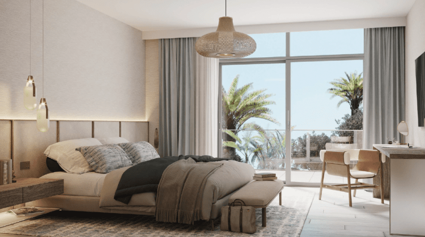 Modern bedroom interior with a comfortable bed, contemporary furnishings, hanging lamps and a large window offering a view of Dubai's palm trees and clear skies.