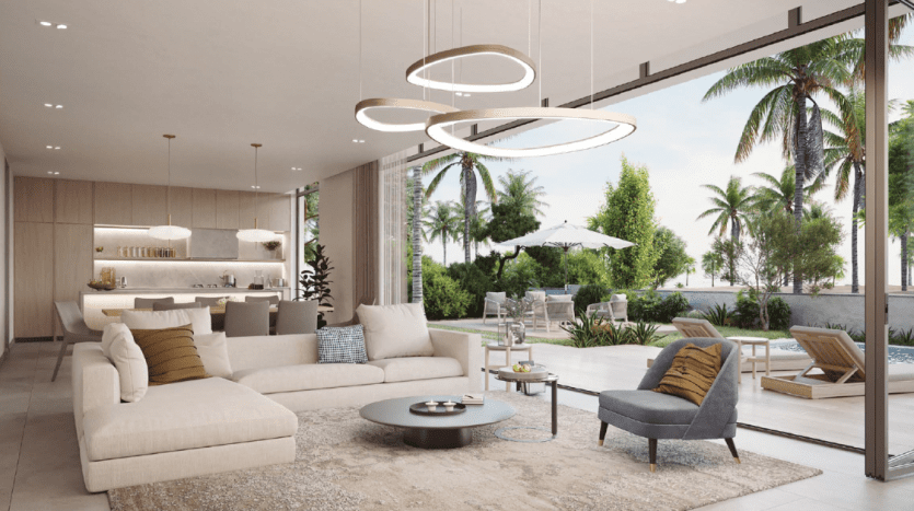 Modern living room with beige sectional sofa, gray chairs, circular light fixtures and glass wall overlooking pool and palm trees. Neutral tones and minimalist design enhance this prime Dubai investment property.