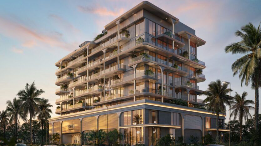 Les résidences Soma, des immeubles modernes à plusieurs étages dotés de grandes baies vitrées, de balcons spacieux agrémentés de plantes et entourés de palmiers, le tout sur fond d'un ciel coloré au coucher du soleil.