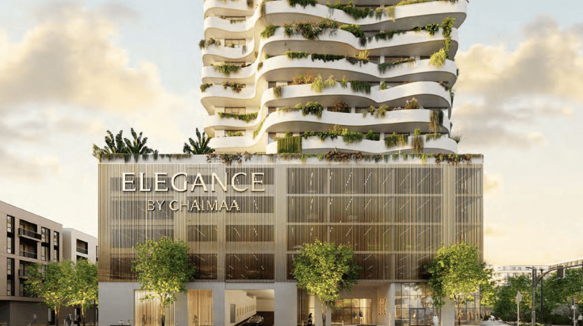 Elegance by chaîma" modern architecture villa with several terraced levels surrounded by greenery, and an exterior lit in an urban setting at dusk.