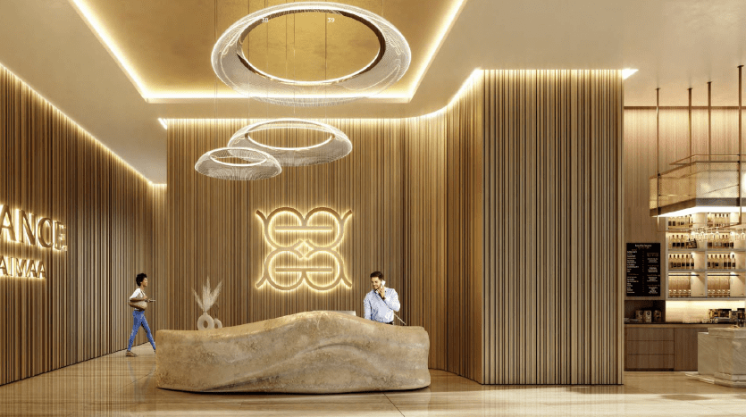 A modern café interior with luminous ring-shaped ceiling lights, a curved wooden bar counter and textured vertical wood panel walls. Neon signage adds a contemporary touch as customers relax and stroll through this Dubai venue.