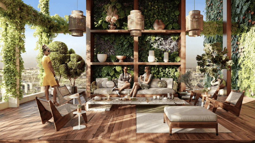 A stylish outdoor terrace with modern wooden furniture, hanging planters, lush greenery and three people relaxing, all under a clear blue sky in a prime Dubai apartment.