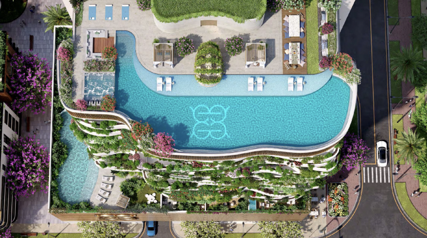 Aerial view of a luxurious rooftop pool in Dubai with a unique curved design, surrounded by lush green plants and equipped with sun loungers and cabanas.