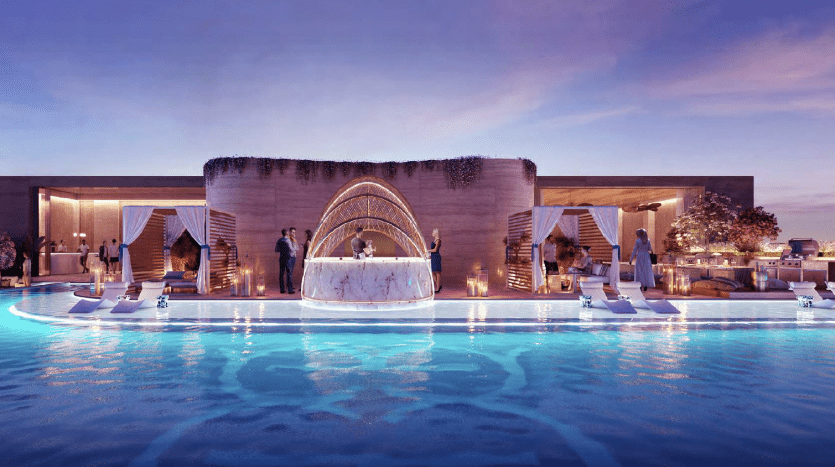 Luxurious open-air wedding reception at dusk with a luminous circular bar in the center of a pool, surrounded by guests, elegant floral arrangements and subdued lighting in an exclusive Dubai real estate setting.