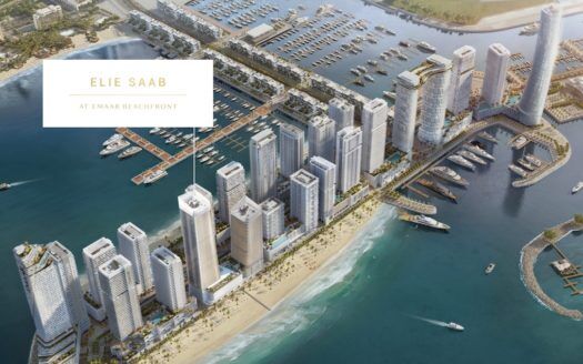 Vista aérea de una urbanización costera de lujo con edificios de gran altura a lo largo de una playa, denominada "elie saab emaar beachfront", rodeada de puertos deportivos con numerosas embarcaciones.