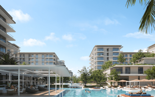 Un lujoso complejo de modernos edificios que rodean una gran piscina con tumbonas y una zona de sombra, con un cielo azul despejado y una exuberante vegetación como telón de fondo, perfecto para los interesados en el sector inmobiliario de Dubai.