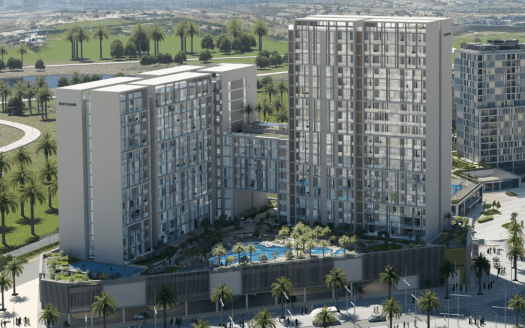 Vue aérienne d'un complexe résidentiel moderne à Dubaï comprenant plusieurs immeubles de grande hauteur aux façades de verre, entourés d'une verdure luxuriante et d'une piscine, situés à proximité d'une zone côtière avec des routes et des parcs visibles