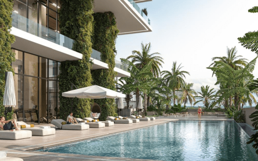Espace piscine luxueux de la marina moderne de Kempinski Dubaï, avec chaises longues, verdure luxuriante et océan en arrière-plan, permettant aux clients de se détendre et de profiter du cadre tranquille.