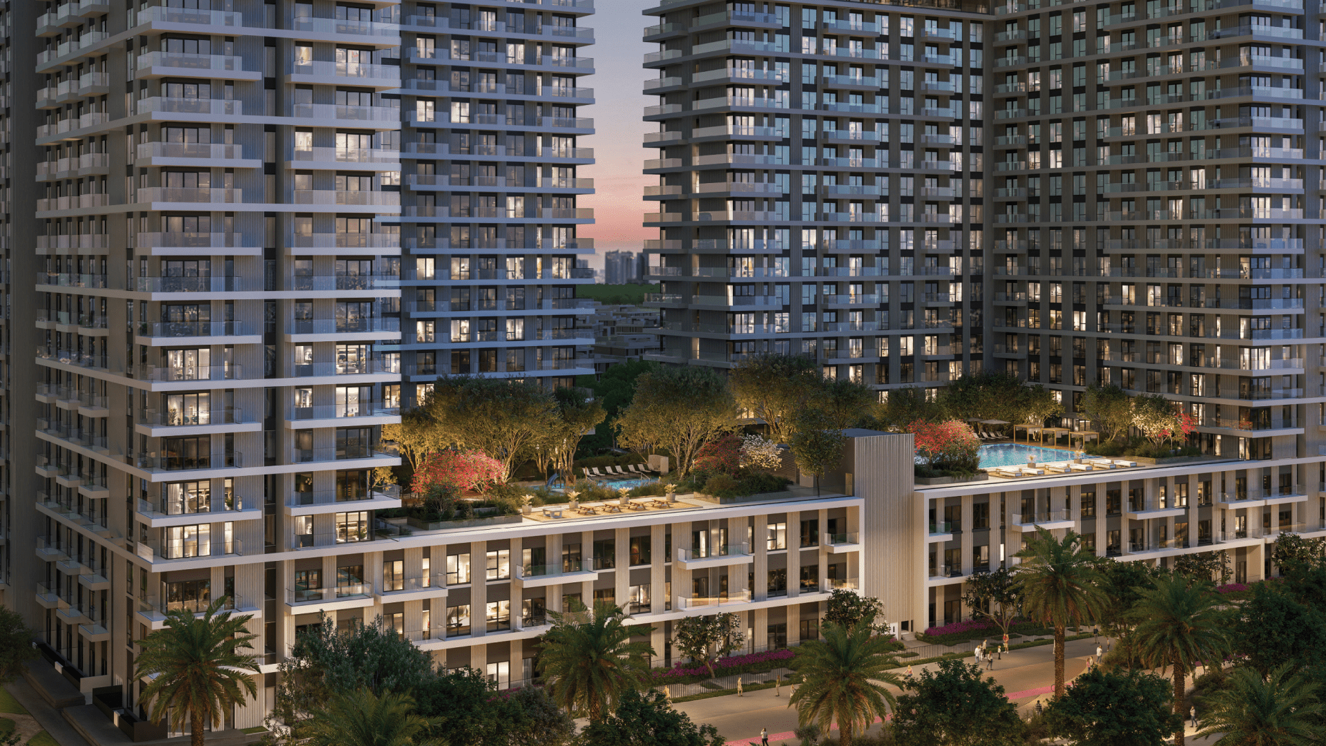 Vida Residences est un complexe résidentiel moderne de grande hauteur composé de deux grands bâtiments reliés par une terrasse paysagée. La terrasse, appelée Club Point, comprend des arbres, une piscine et des coins salon. La scène se déroule au coucher du soleil avec les lumières de la ville scintillant en arrière-plan.