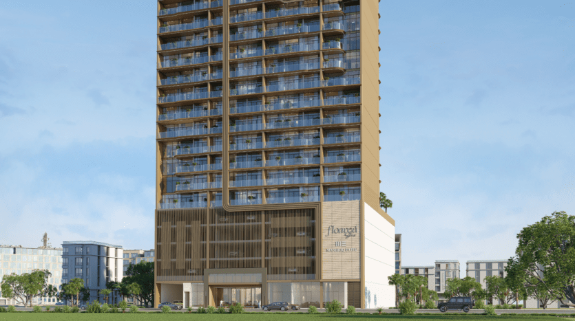 Un grand bâtiment moderne avec des balcons en verre et une façade brun doré, marqué « Avagat » près de l'entrée. Des voitures et des arbres sont visibles devant, tandis que d'autres bâtiments s'élèvent à proximité sous le ciel clair de Floarea.