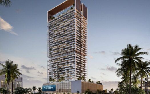 Une tour moderne dotée de nombreux balcons et d'une terrasse sur le toit se dresse au milieu des palmiers au coucher du soleil dans la ville maritime de Dubaï. La partie inférieure comporte un panneau "YACHTING", évoquant l'élégance de Franck Muller Yachting à Dubai Maritime City. Le ciel est partiellement nuageux.