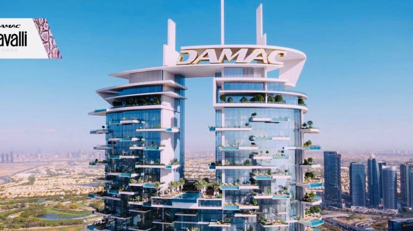 Aerial view of the modern Roberto Cavalli Tower in Dubai, a high-rise building with glass facades and unique architectural levels, set on the city's rooftops under a clear blue sky.