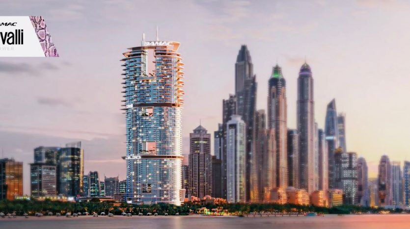 A panoramic view over the rooftops of a modern city with the eminent Roberto Cavalli Tower in Dubai, a high-rise building with unique cylindrical architecture, contrasting with other skyscrapers at sunset.