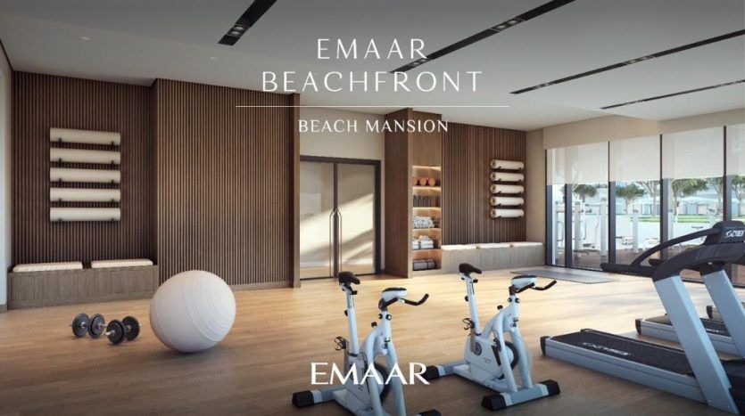 Innenausstattung eines modernen Fitnessraums mit Trainingsfahrrädern, Laufband, Hanteln und einem großen Übungsball, in einem Raum mit der Aufschrift "marina sands beach mansion" mit großen Fenstern und Holzakzenten.