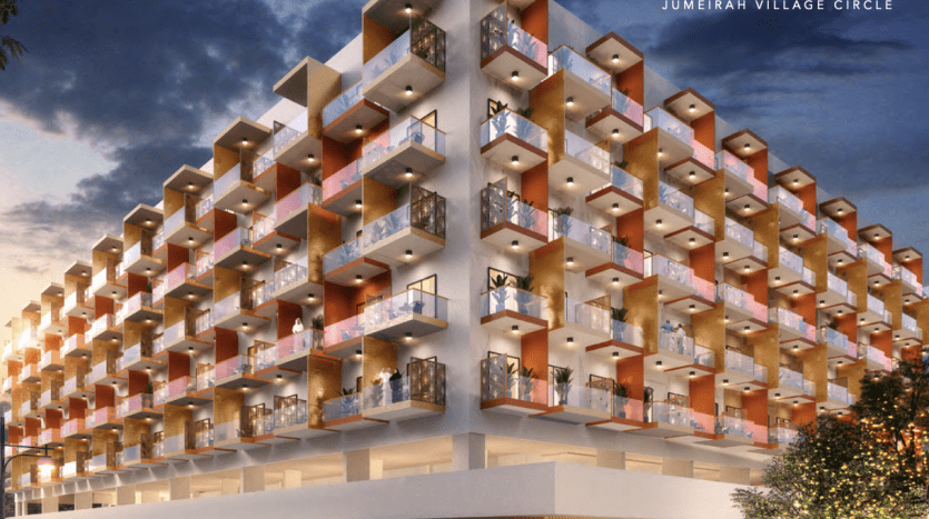 Rendu architectural du bâtiment Binghatti Rose au crépuscule à Jumeirah Village Circle, présentant un design moderne avec des balcons décalés éclairés par des lumières chaudes, représentant le premier immobilier de Dubaï
