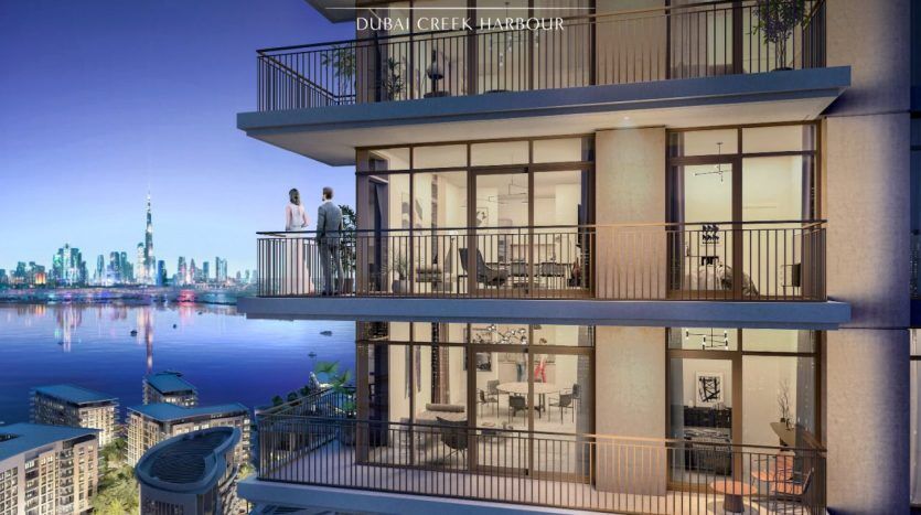 Architectural rendering of the Creek Palace in Dubai Creek harbor, featuring stacked balconies with two people overlooking the city's rooftops and waterfront. The "Emaar" logo is visible at bottom right.