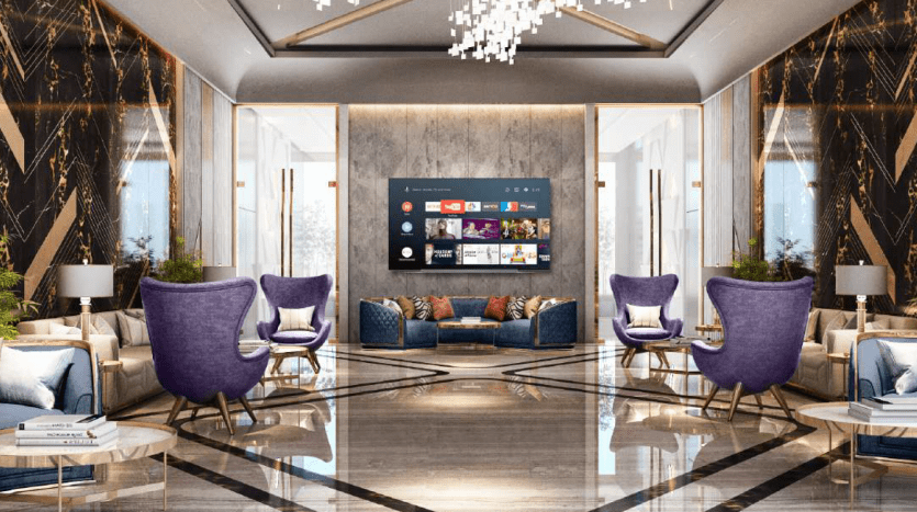 Luxurious hotel lobby with symmetrical design, featuring purple chairs, geometrically patterned marble floors and a large TV screen on the wall. The décor includes elegant chandeliers and gold accents, recalling