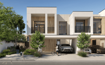 Maisons en rangée modernes aux lignes épurées, dotées de façades en bois et en béton, de grandes fenêtres et de balcons. Cette villa à Dubaï dispose d'une rue paysagée avec des voitures garées, un cycliste et une personne