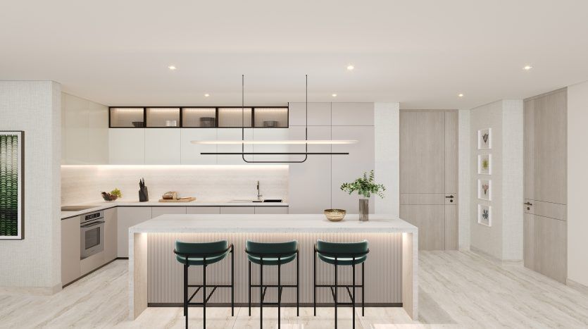 Modern kitchen interior with white cabinets, central island with teal bar stools, pendant lighting and integrated appliances. The space is decorated with decorative plants and subtle lighting in a luxurious Dubai villa.