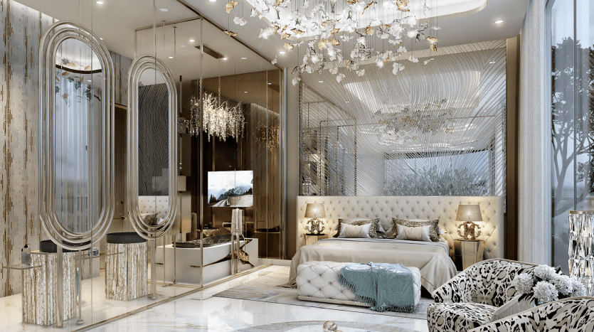 Luxurious bedroom with Cavalli Couture elegance, featuring a plush bed, intricate chandelier and stunning ceiling design. The room features mirrored walls and a comfortable sitting area with patterned chairs. Large windows invite natural light to enhance the golden accents and modern furnishings.