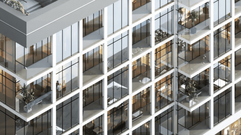 Aerial view of the facade of a modern office building in Dubai, showing interior details through glass windows, with visible office furniture and green plants.
