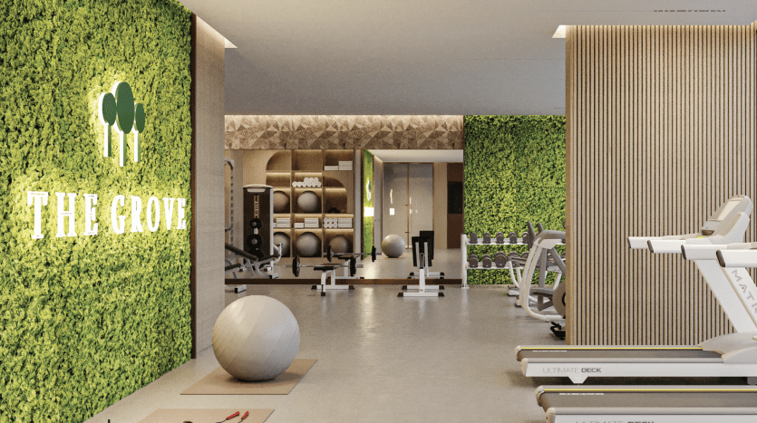 Modern gym interior in a Dubai apartment, with green plant walls labeled "le bosquet", treadmills, exercise balls and weights. Elegant, well-lit space overlooking a