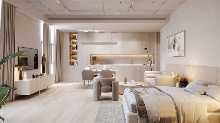 Interior of a modern studio in Dubai featuring a bed, living area, kitchenette and dining space, all decorated in neutral tones with natural light and green plants accentuating the comfortable, elegant design.