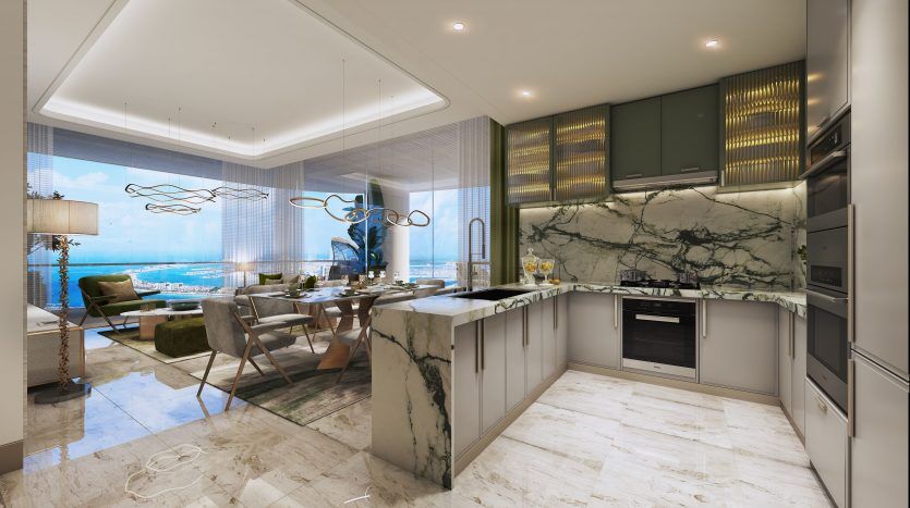 Luxueuse cuisine ouverte avec comptoirs et sols en marbre, dotée d'appareils modernes et d'un coin repas donnant sur l'océan à travers des baies vitrées dans une villa de Dubaï.