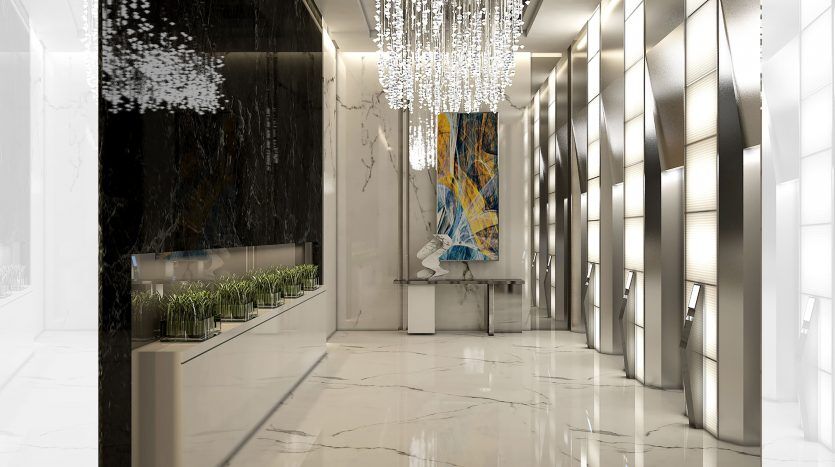 Intérieur luxueux et moderne du hall d'un appartement de Dubaï avec des sols en marbre réfléchissant, des panneaux muraux artistiques, une grande peinture abstraite colorée et un lustre orné suspendu au-dessus.