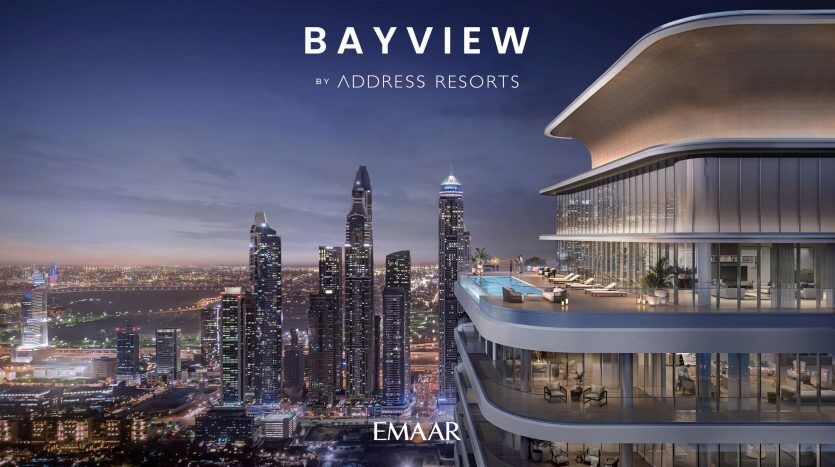 Une image promotionnelle pour Bayview par Address Resorts présentant l'extérieur éclairé d'une villa de luxe moderne au crépuscule avec une ligne d'horizon de gratte-ciel imposants à Dubaï en arrière-plan.