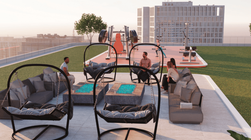 Espace de rassemblement sur le toit doté d'un mobilier d'extérieur moderne dans un contexte urbain au coucher du soleil, avec des gens socialisant et utilisant des équipements d'exercice dans un emplacement privilégié d'une villa à Dubaï.