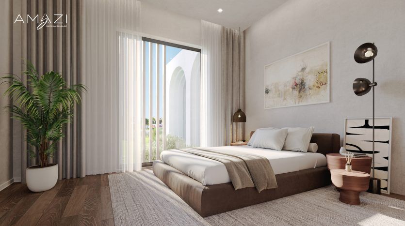 Chambre minimaliste avec un grand lit, des murs de couleur claire et du parquet. Il dispose d'une grande fenêtre, d'œuvres d'art modernes sur le mur et d'accents comme une plante en pot et une table de nuit géométrique.
