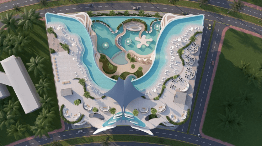 Vue aérienne d'un parc aquatique en forme de papillon entouré de palmiers, comprenant diverses piscines, toboggans et espaces de détente, adjacent à une rue à proximité d'une agence immobilière de Dubaï.