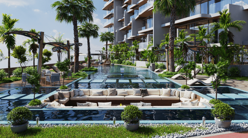 Une piscine extérieure luxueuse avec des sièges intégrés, entourée de bâtiments résidentiels modernes et d'une verdure luxuriante à Dubaï, reflétant une atmosphère sereine et haut de gamme.