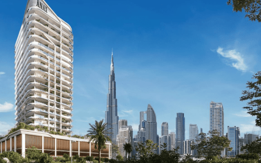 Un moderno edificio residenziale in primo piano, dal design unico e curvilineo, che si staglia su uno skyline caratterizzato dal Burj Khalifa e da altri grattacieli sotto un cielo azzurro e limpido, rappresenta il premio immobiliare di Dubai.