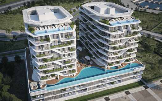 Vista aerea di due lussuose ville multipiano a Dubai con piscina sul tetto, circondate da una vegetazione lussureggiante in una zona costiera.