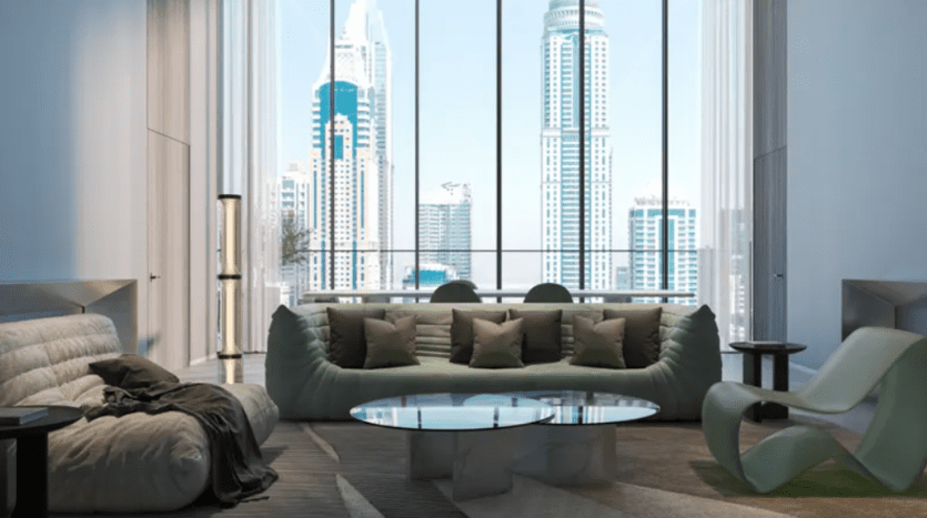 Luxurious, modern living room with large picture windows showing an urban landscape with tall skyscrapers. The room features a plush gray sofa, green armchairs, a glass coffee table and minimalist decorative elements, creating an airy, sophisticated atmosphere.