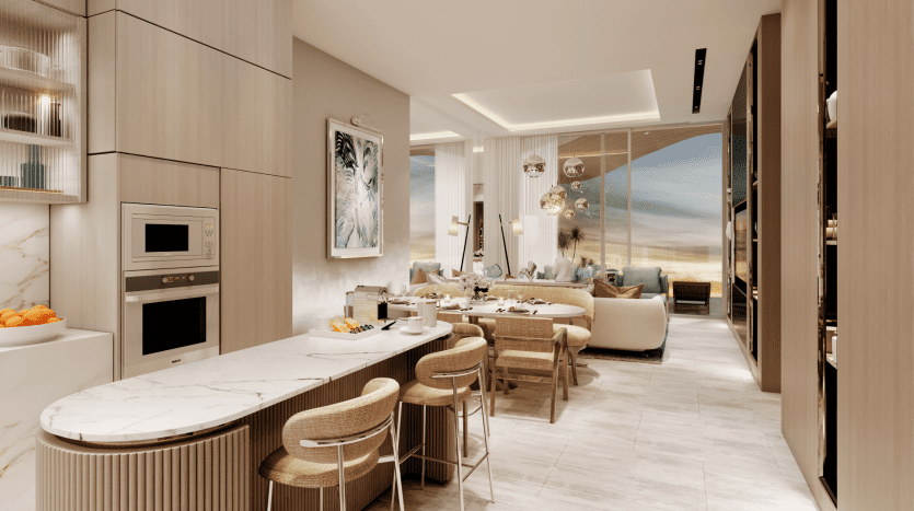A modern, open-plan kitchen and living room with neutral tones and natural materials. The Pier kitchen features a marble island with seating, integrated appliances and shelving. The living room features a comfortable sofa, hanging lamps and large windows offering panoramic views.