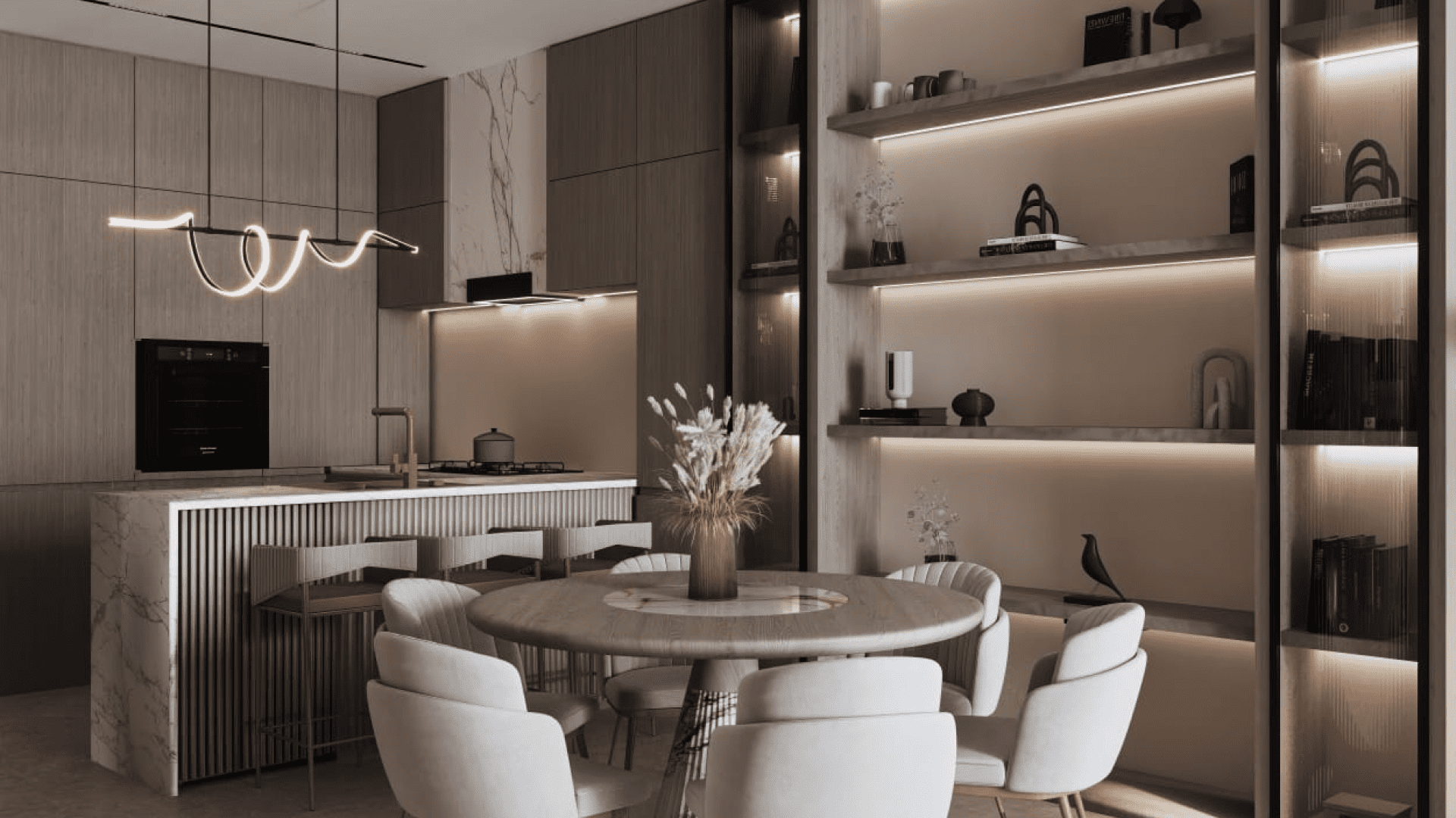 La cuisine moderne avec coin repas de la Maison Elysee 3 présente des tons beiges et marron. Elle dispose d'un îlot en marbre avec des tabourets de bar, d'un luminaire élégant au-dessus et d'armoires en bois. La salle à manger comprend une table ronde avec des chaises blanches et des étagères décorées et éclairées en arrière-plan.