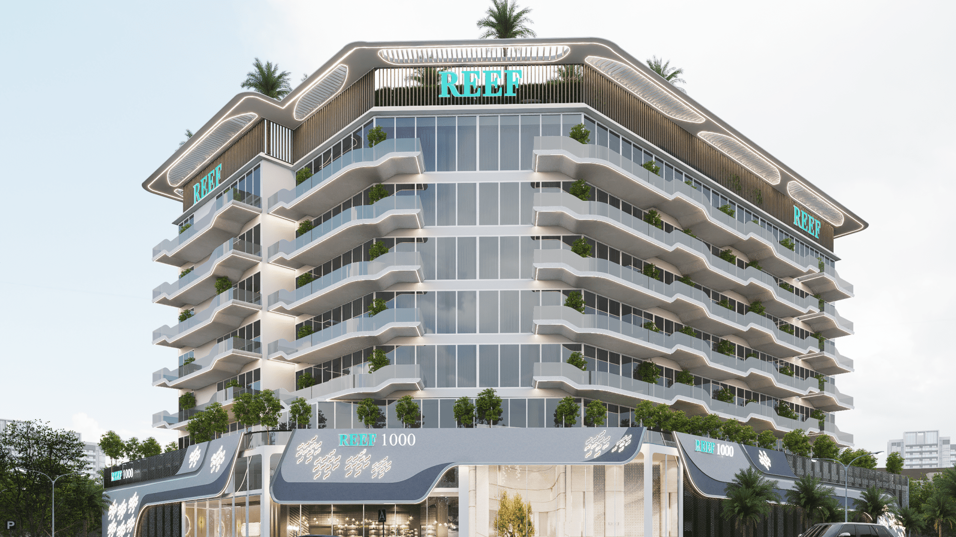 Un bâtiment moderne à plusieurs étages avec des balcons en verre et des plantes vertes à chaque étage. La structure est étiquetée « Reef » et dispose de verdure sur le toit. La base du bâtiment porte une signalisation indiquant « Reef 1000 ». Des arbres et un ciel dégagé sont visibles.