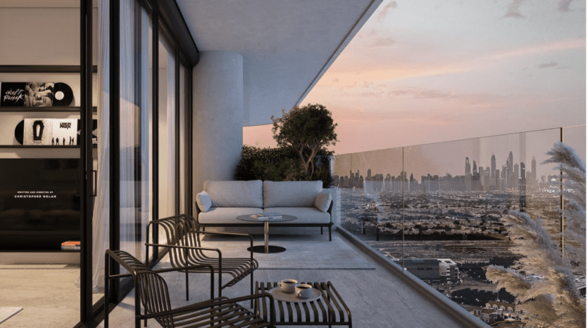 Balcon moderne au coucher du soleil avec une balustrade en verre, un petit canapé, deux chaises à rayures, une table ronde et des plantes en pot. La ligne d'horizon de la ville est visible au loin sous un ciel coloré.