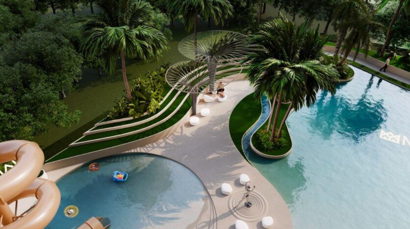 Vue aérienne de la piscine extérieure du Marquis One Arjan, qui comprend une piscine incurvée, des palmiers, des chaises longues, des structures d'ombrage sculpturales et un toboggan aquatique, le tout entouré d'une végétation luxuriante.