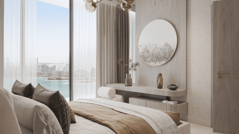 Une chambre à coucher moderne et minimaliste avec des tons neutres, un grand lit, un miroir rond au-dessus d'une commode élégante et des fenêtres allant du sol au plafond offrant une vue sur l'eau et l'horizon lointain de la ville.