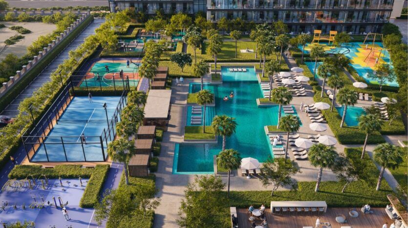 Aerial view of Sierra by Iman, a modern outdoor leisure area featuring swimming pools, tennis and basketball courts, playgrounds, sun loungers, shaded seating areas and landscaped green spaces. People enjoy a variety of activities throughout the area.
